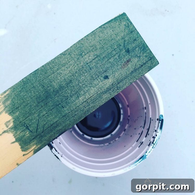 A test piece of wood showcasing the vibrant Sea Blue Behlen Solar Lux stain, illustrating its rich color.