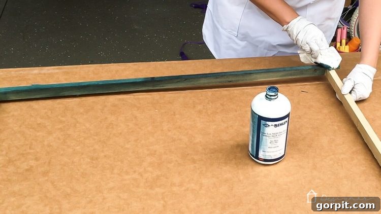 A freshly stained DIY frame in a vibrant Sea Blue, ready for the print to be mounted, adding a pop of color to the room.