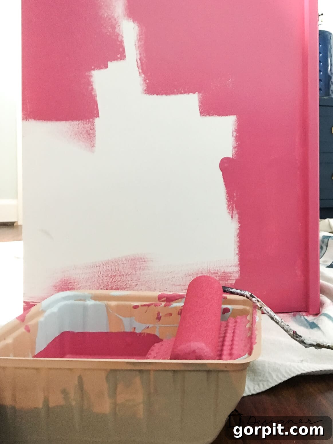 Unlock Massive Storage Potential with an IKEA Billy Hack 3 Pink paint halfway applied to a white IKEA Billy bookcase.