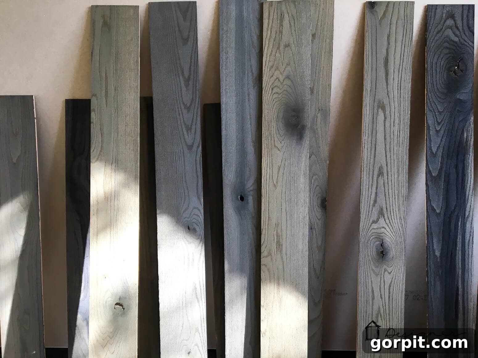 Unlock Massive Storage Potential with an IKEA Billy Hack 5 Wood stacked against a wall to be used as the IKEA Billy bookcase pallet back.