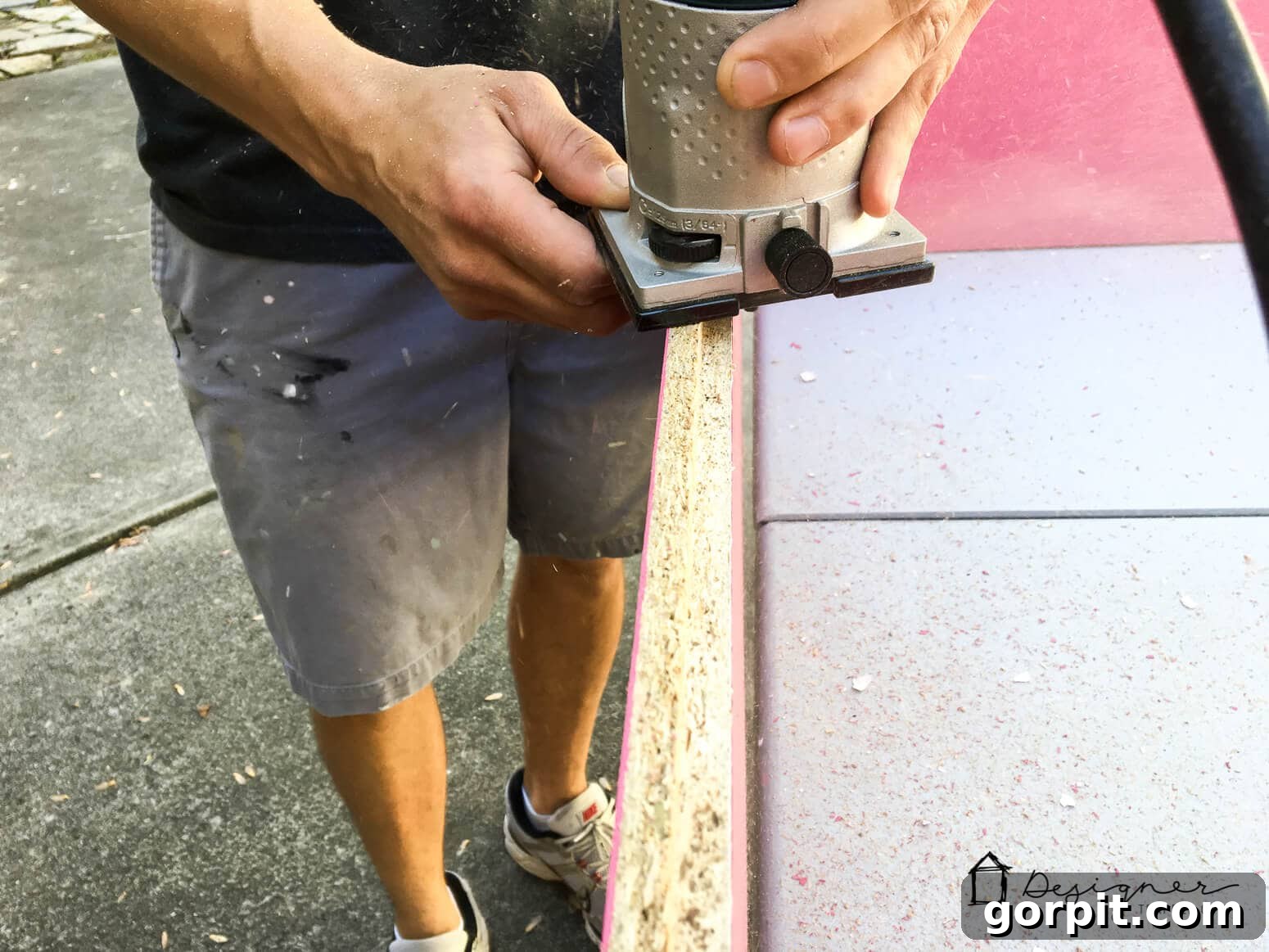 Unlock Massive Storage Potential with an IKEA Billy Hack 6 A man sands the edges of wood as part pf the IKEA Billy bookcase hack.