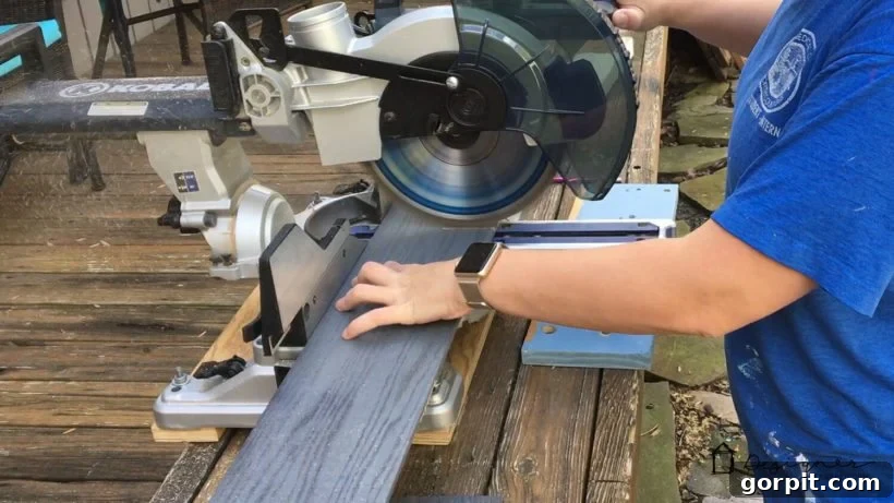 Unlock Massive Storage Potential with an IKEA Billy Hack 7 A man uses a table saw to cut wood planks for use on an IKEA Billy bookcase hack.