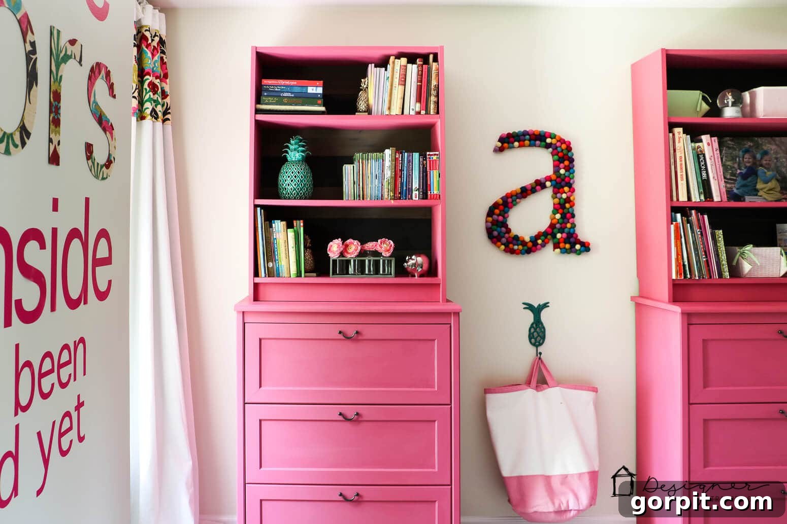 Unlock Massive Storage Potential with an IKEA Billy Hack 9 The finished IKEA Billy bookcase hack in a girl's room show pink dressers with bookshelves above and a colorful
