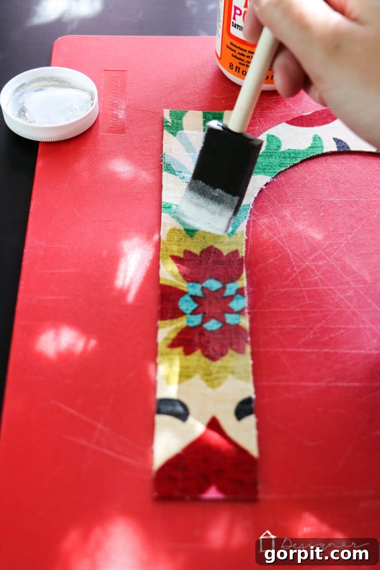Seal fabric letters with Mod Podge to prevent fraying and secure them with double-sided poster tape.