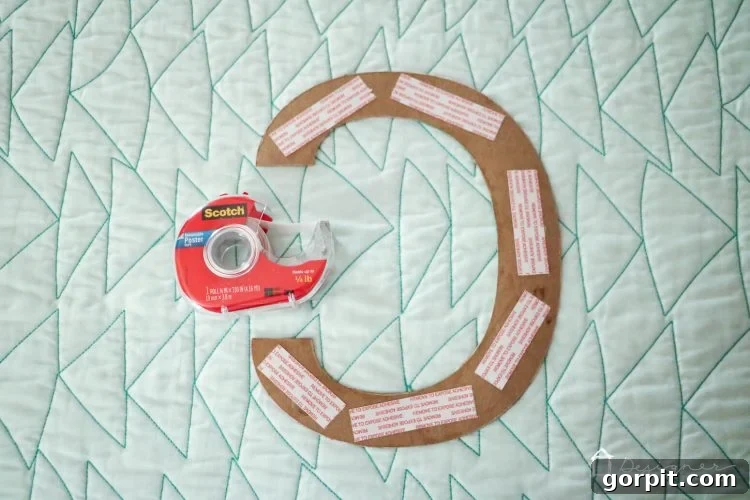 The vibrant fabric letters add a unique, personalized touch to your DIY wall quote.