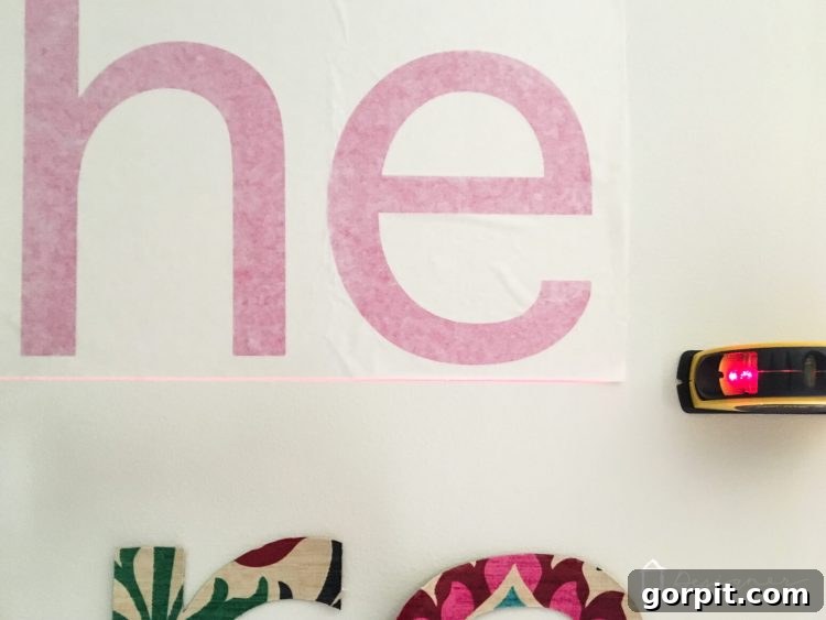 Align and apply your custom vinyl wall decals to create a stunning, personalized wall quote.