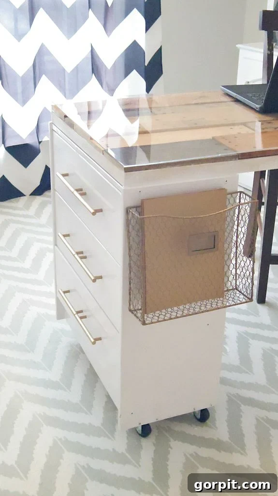 Smart IKEA Desk Upgrades for Less 10 A glass top on a wooden desk made from IKEA drawers against a blue and white chevron curtain.