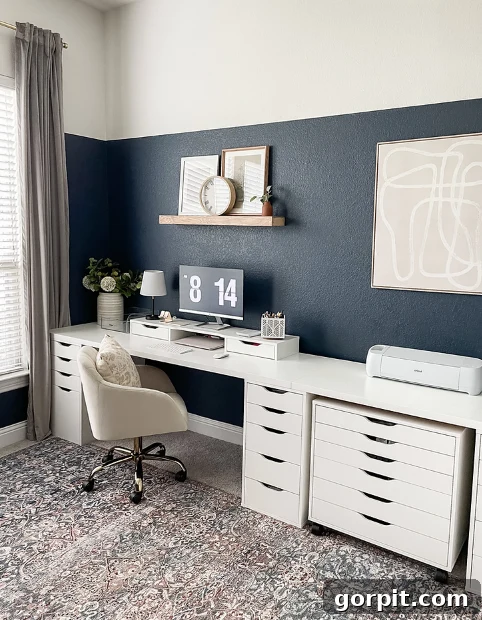 Smart IKEA Desk Upgrades for Less 14 IKEA desk setup for office craft room includes a long white countertop, plenty of drawers underneath, a blue color block wall and space for a Cricut machine.