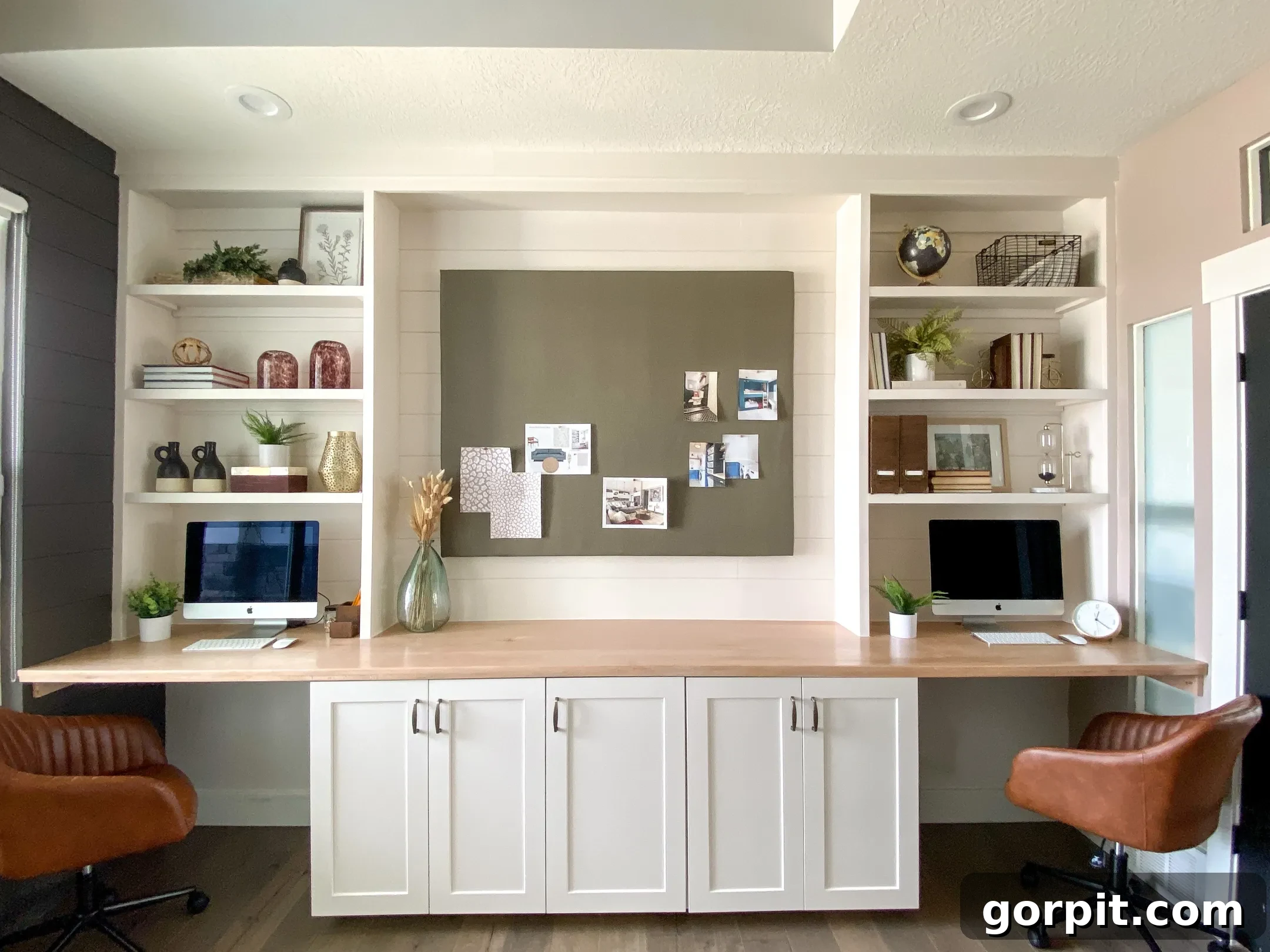 Smart IKEA Desk Upgrades for Less 16 A wood countertop the length of the wall with cabinets underneath and tall bookshelves on either side create a two-person work area from an IKEA desk hack.