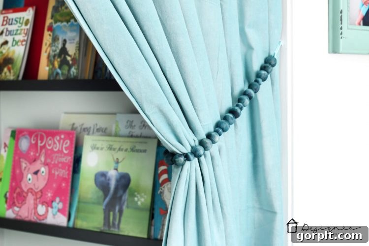 Detailed shot of the custom blue wood bead tie back perfectly complementing a light-colored curtain.