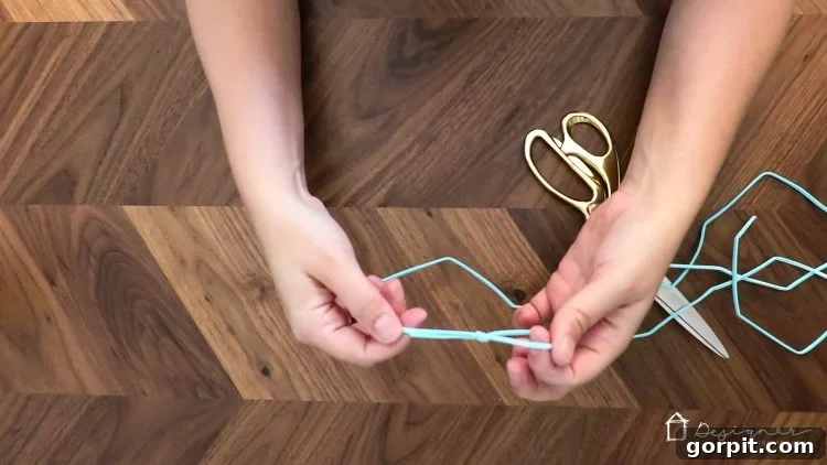 A suede cord with a neatly tied loop knot at one end, ready for bead threading.