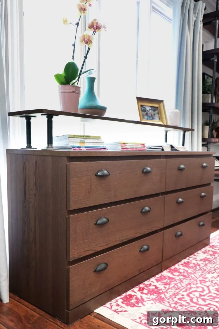 A closer view of the finished industrial Ikea Malm dresser, highlighting the new drawer pulls and the dark wood top.