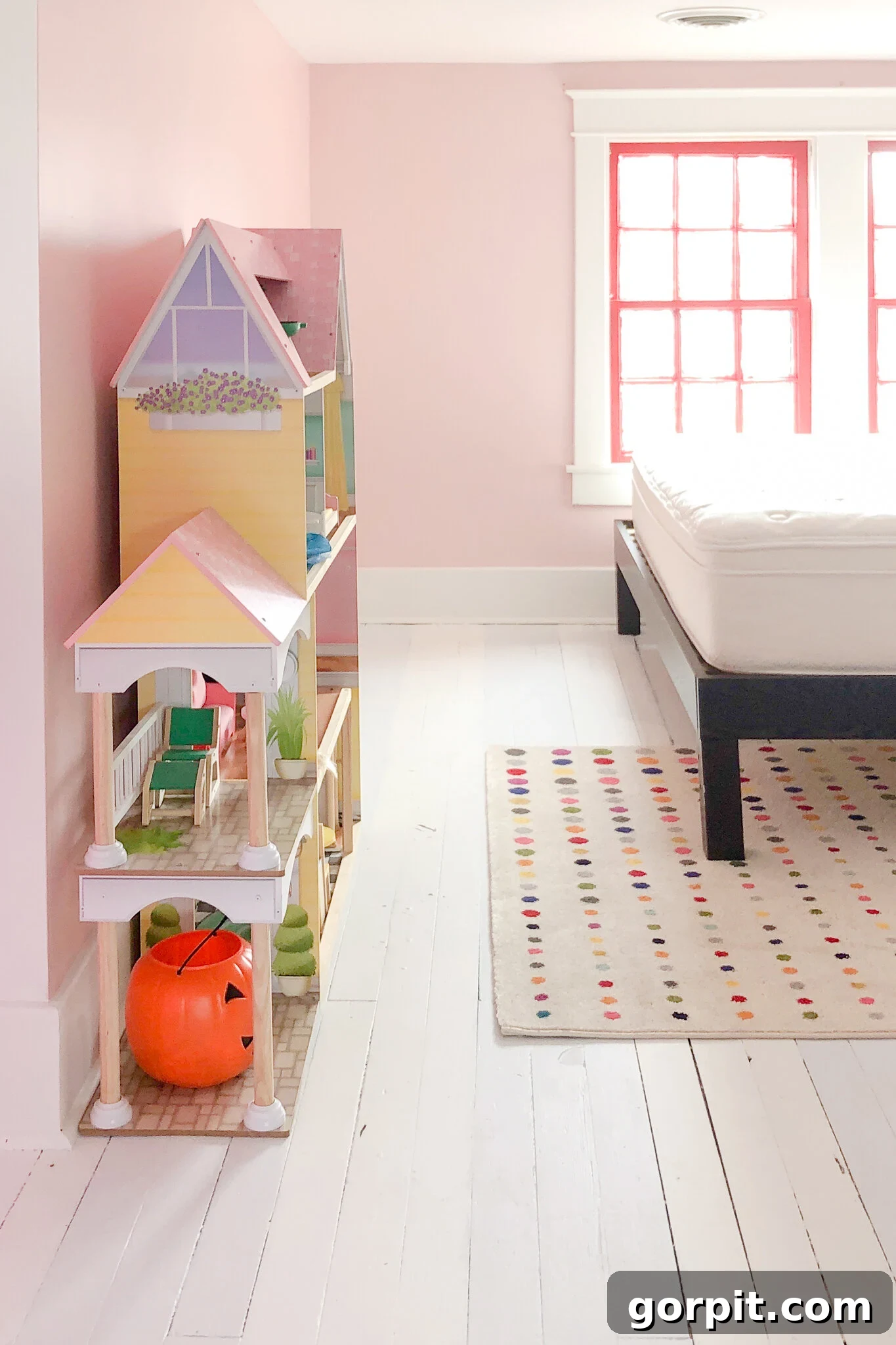 Elegant white painted hardwood floors in a vibrant, colorful room, demonstrating how paint can dramatically refresh old wood floors.