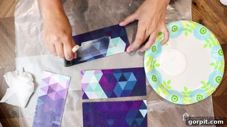 Precisely cut fabric-covered chipboard rectangles, ready for the final Mod Podge seal and drying.