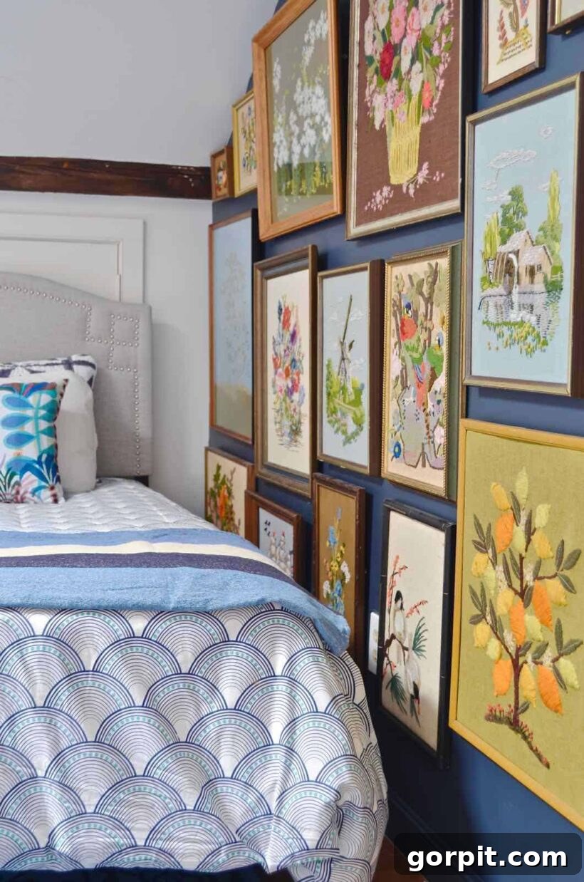 Floor-to-ceiling bedroom gallery wall with embroidered art