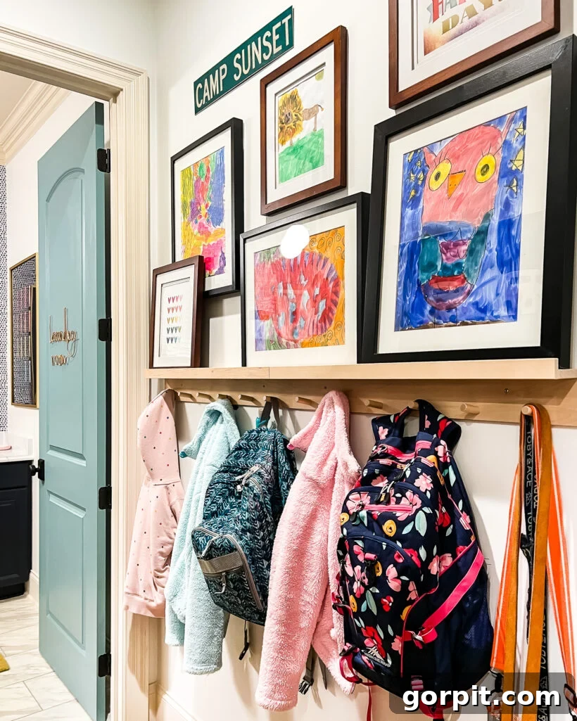 Mudroom gallery wall featuring children's art