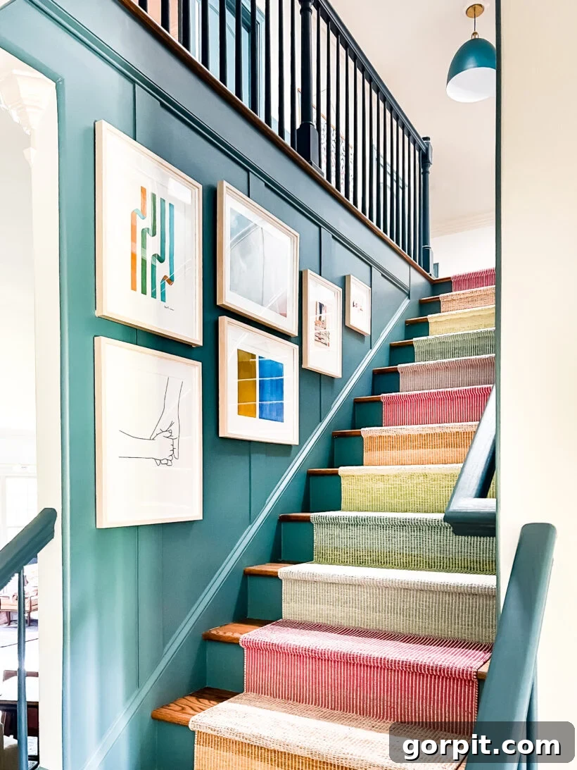 Colorful art hanging in staircase with updated railing