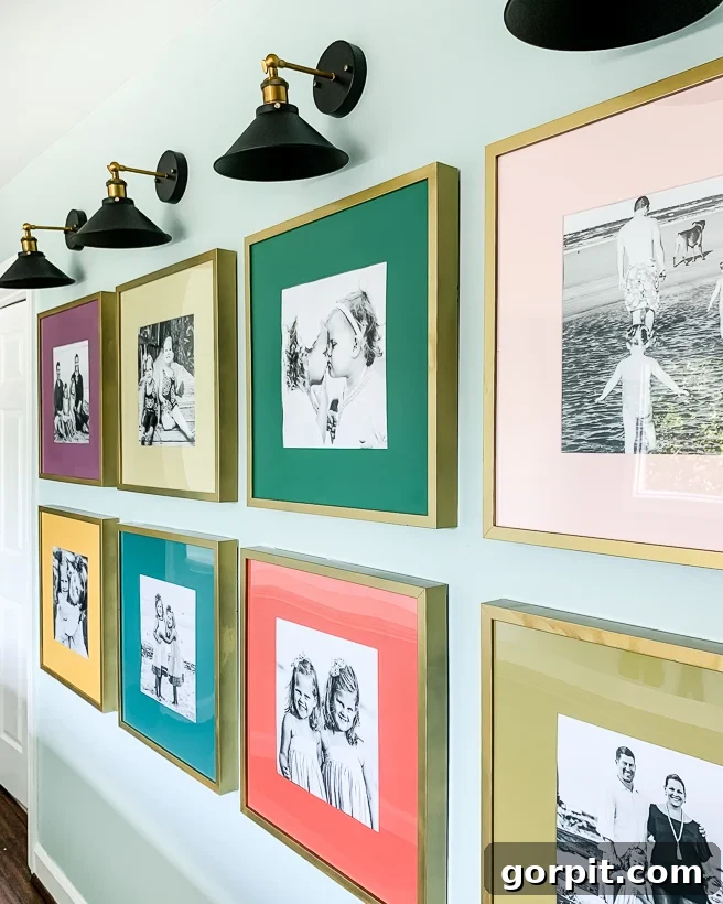 Colorful hallway gallery wall of family photos with custom mats