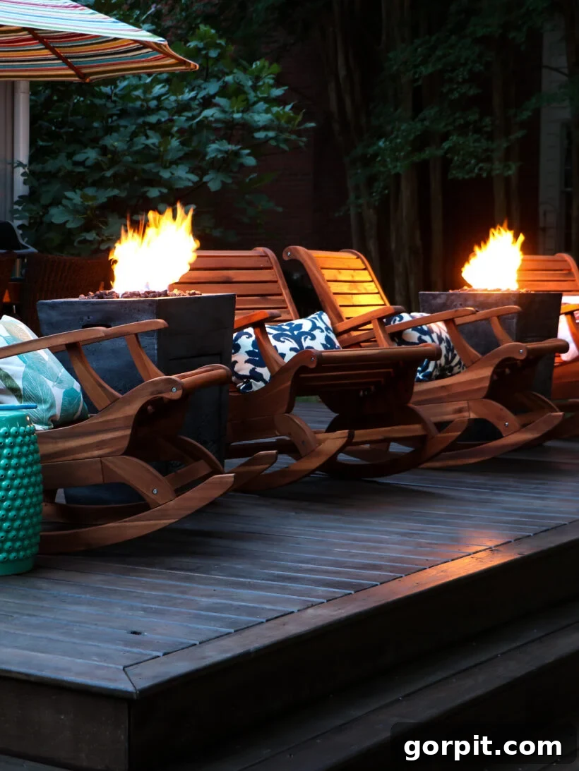 Two modern fire columns providing warmth and ambiance on the newly renovated deck, positioned between rocking chairs, enhancing the outdoor living experience.