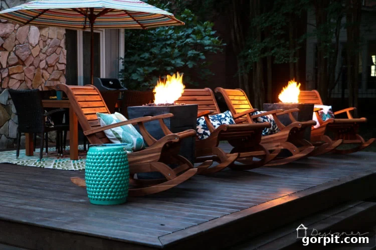 A wide shot of the deck at night, with the fire columns casting inviting light, demonstrating the successful transformation into a luxurious outdoor space.