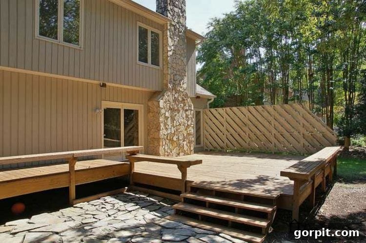 Another before photo of the 31-year-old deck, highlighting its worn condition and the original, unappealing orange stain that prompted the DIY makeover.