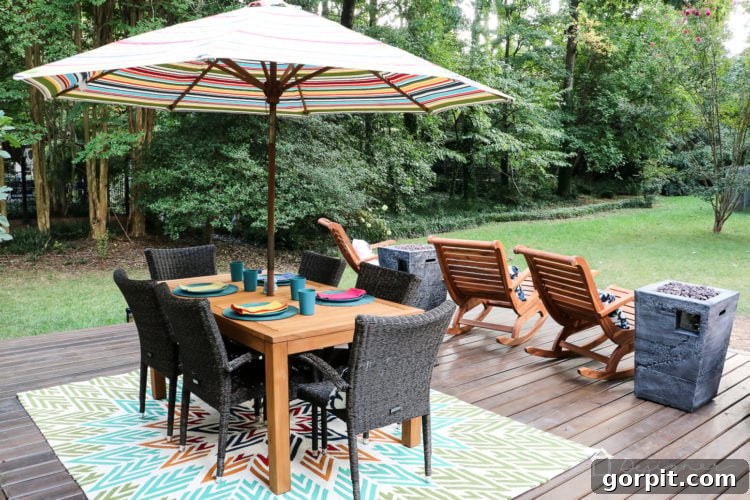 Close-up of the outdoor dining area on the new deck, featuring a Teak table and stylish all-weather wicker chairs, perfectly blending different material preferences.