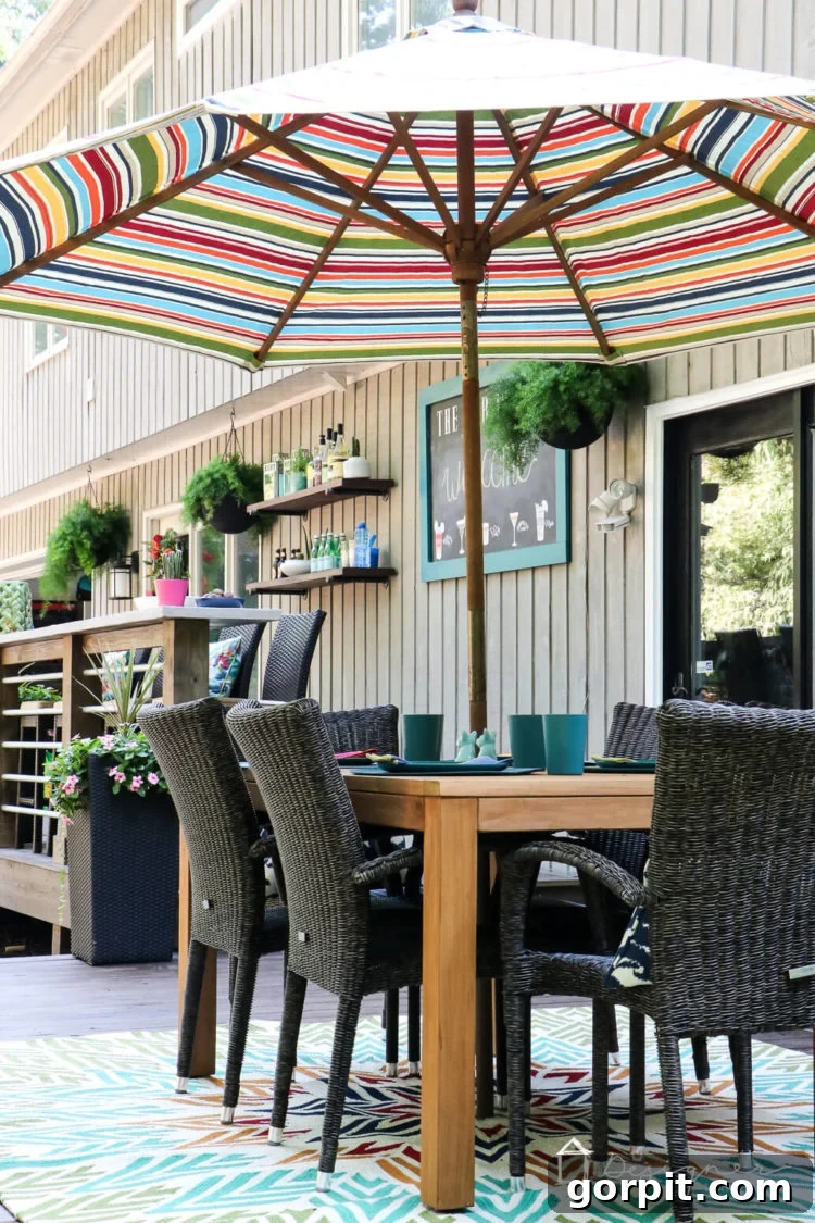 Detail shot of the comfortable outdoor seating on the renovated deck, featuring a harmonious mix of natural wood and all-weather wicker furniture, creating an inviting atmosphere.