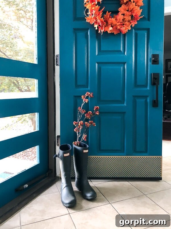 Effortless Door Kick Plate DIY 8 The elegant gold kick plate beautifully complements the blue door, creating a stunning and protected entryway with a seamless, screw-free finish.