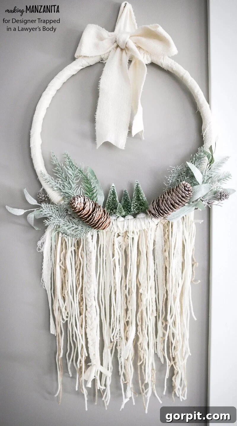 Finished DIY Boho Winter Wreath hanging on a white door, showcasing its full design