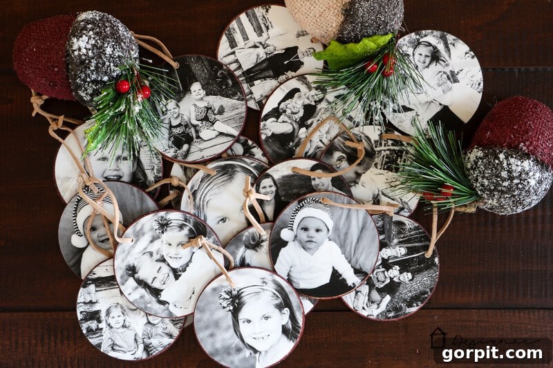 Close-up of finished DIY photo Christmas ornaments hanging on a decorated Christmas tree.