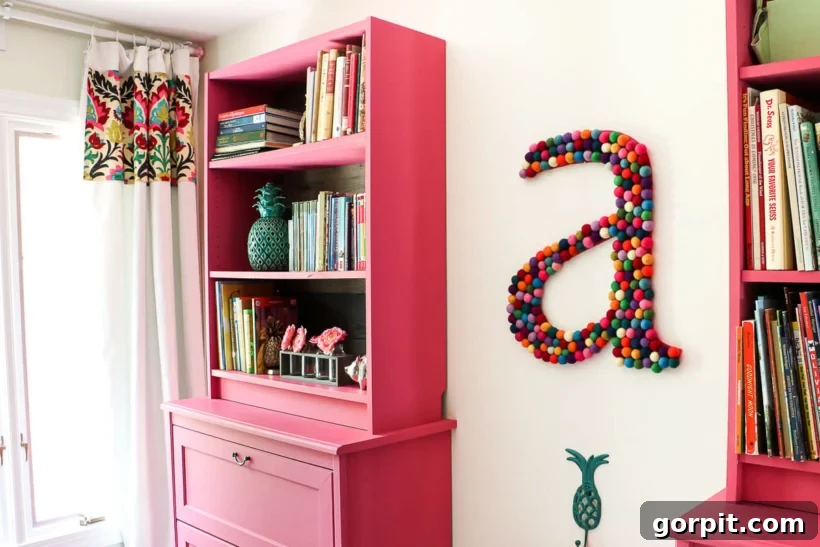 A beautifully organized girls' bedroom featuring painted IKEA Billy bookcases, integrated seamlessly into the custom built-in design.