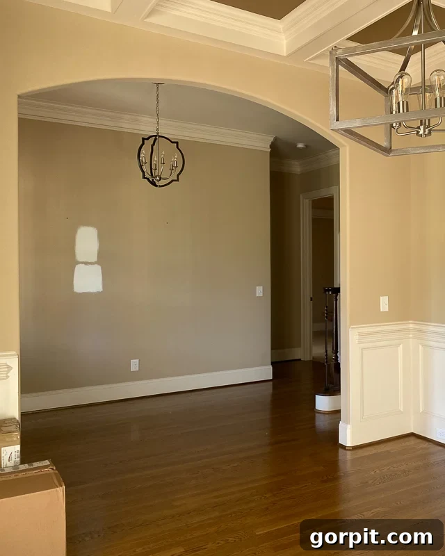 Make Small Rooms Feel Bigger 9 Genius Hacks 10 An empty hardwood floor room has a wide arch into an empty hallway.