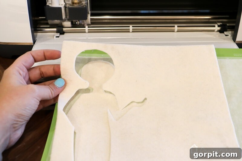 Creative Felt Doll Kit 8 Using a Cricut Maker with a rotary blade to precisely cut the felt doll body, achieving perfect, clean edges.