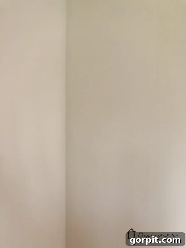 A pristine, blank wall after a successful and invisible drywall repair.
