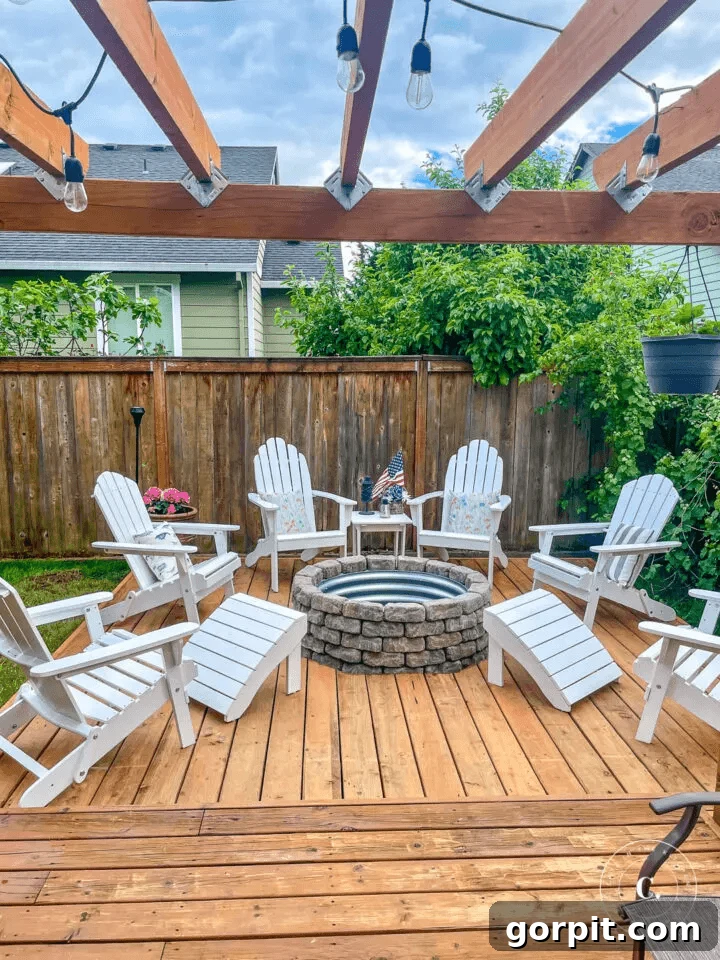 A DIY fire pit idea includes a floating deck uses galvanized steel and a pergola covered with lights, creating a unique and enchanting outdoor space.