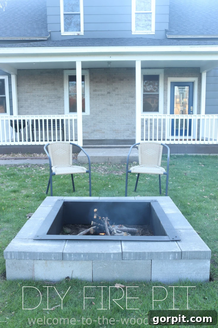 A square fire pit sits in the center of a backyard with square pavers leading from the white porch to the fire pit, embodying modern outdoor design.