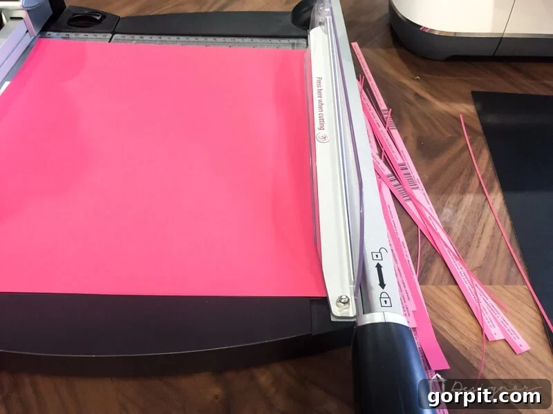Elevate Your Photos: DIY Mats on a Budget 3 Trimming cardstock to the correct 12x12 inch size for a DIY picture mat project.