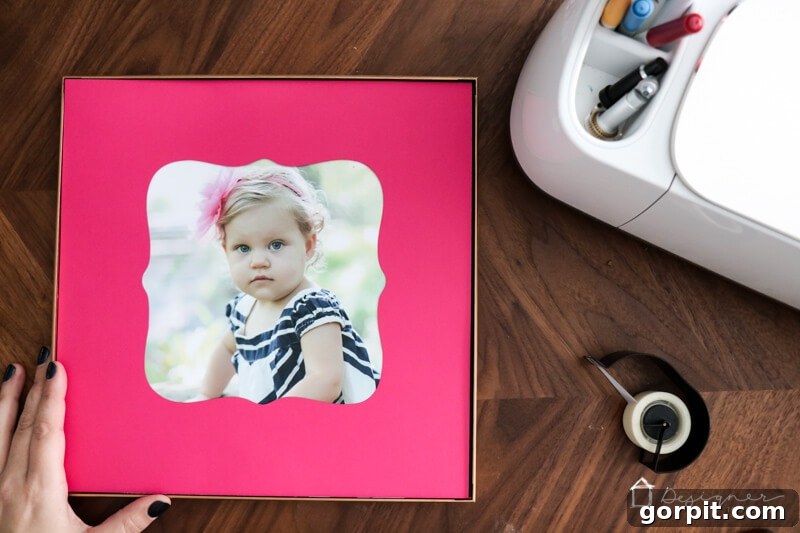 Elevate Your Photos: DIY Mats on a Budget 7 A framed photo with a DIY pink picture mat, showcasing a family moment.