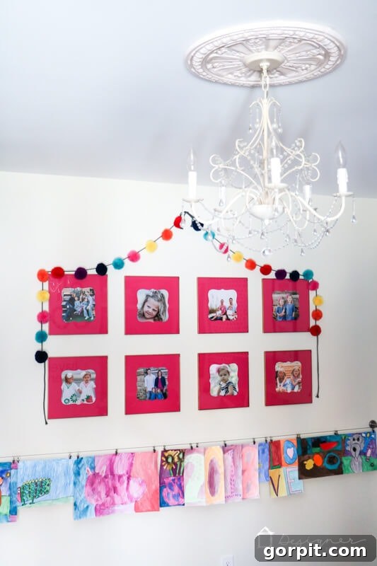 Elevate Your Photos: DIY Mats on a Budget 8 A vertical shot of a framed family photo with a pink custom mat, part of a gallery wall.