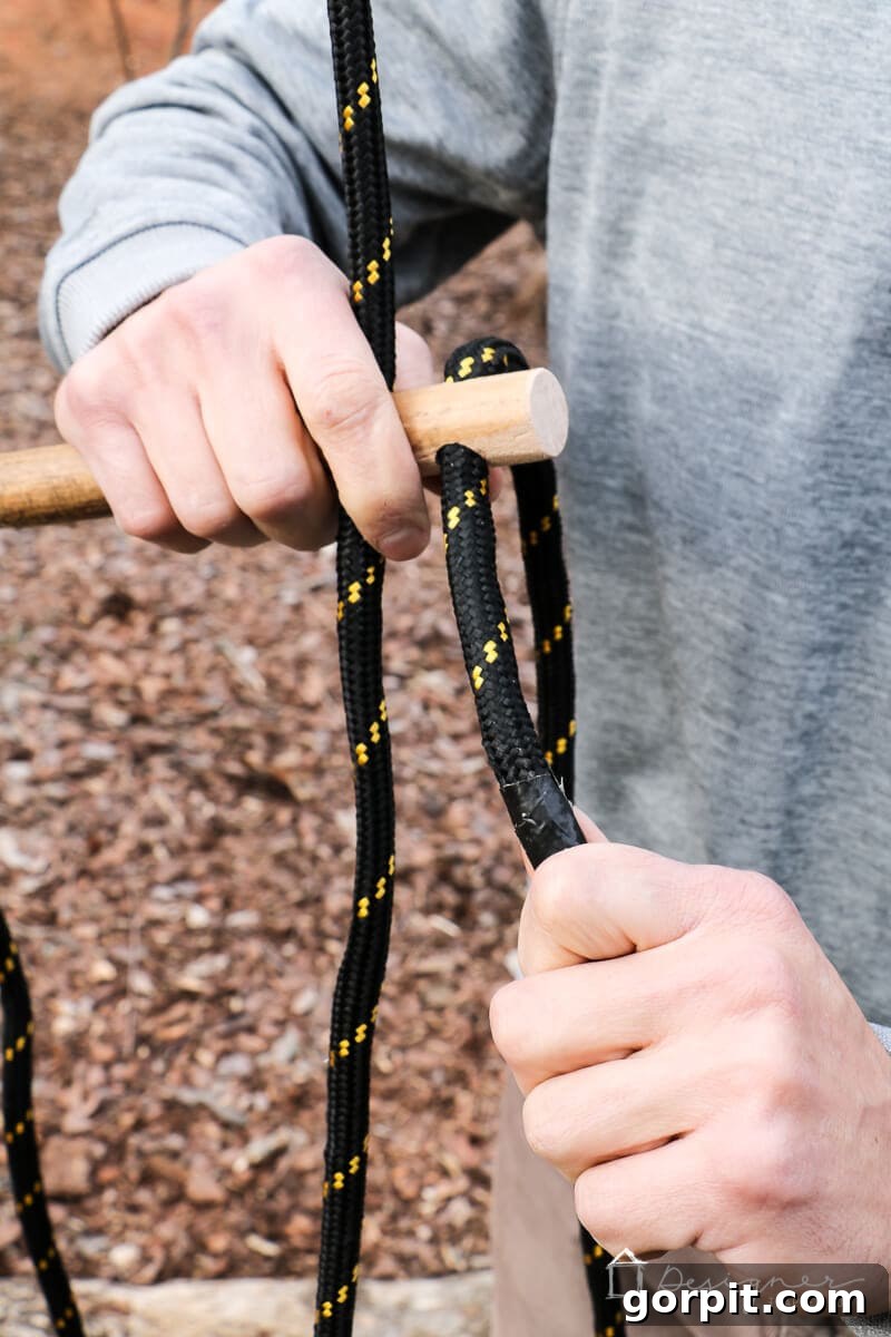 An assembled handle with rope threaded through, demonstrating the adjustable mechanism.