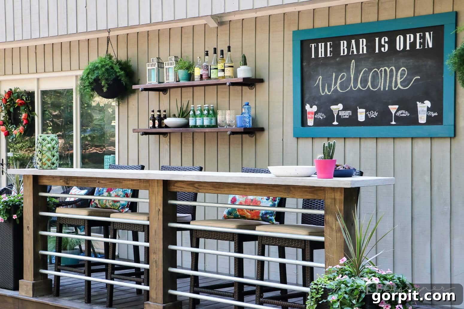 Build a Custom Outdoor Chalkboard 12 A wide shot of the outdoor chalkboard installed on a deck wall, next to a DIY bar