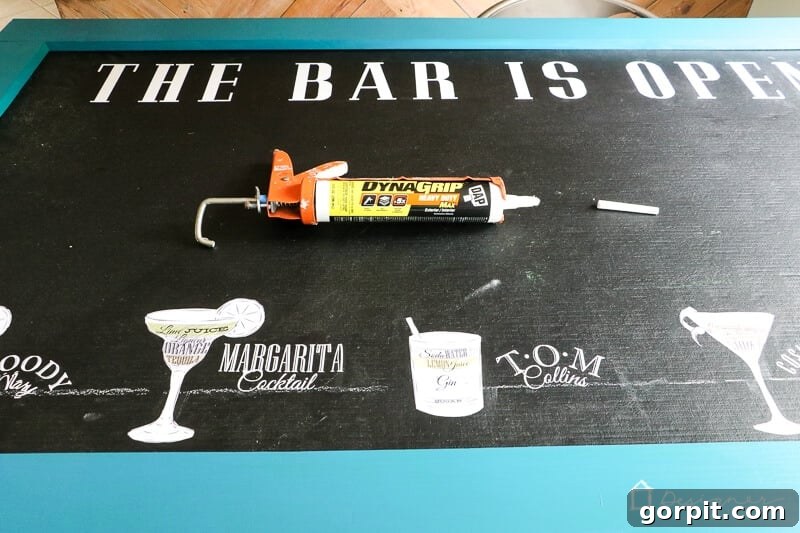 Build a Custom Outdoor Chalkboard 7 A corner of the chalkboard frame being clamped to the board while adhesive dries