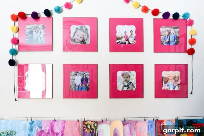 Gold frames with custom pink mats hung in Attley's room
