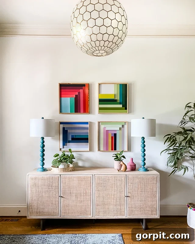 Colorful graphic art in a bright entryway featuring Pure White by Sherwin-Williams walls.