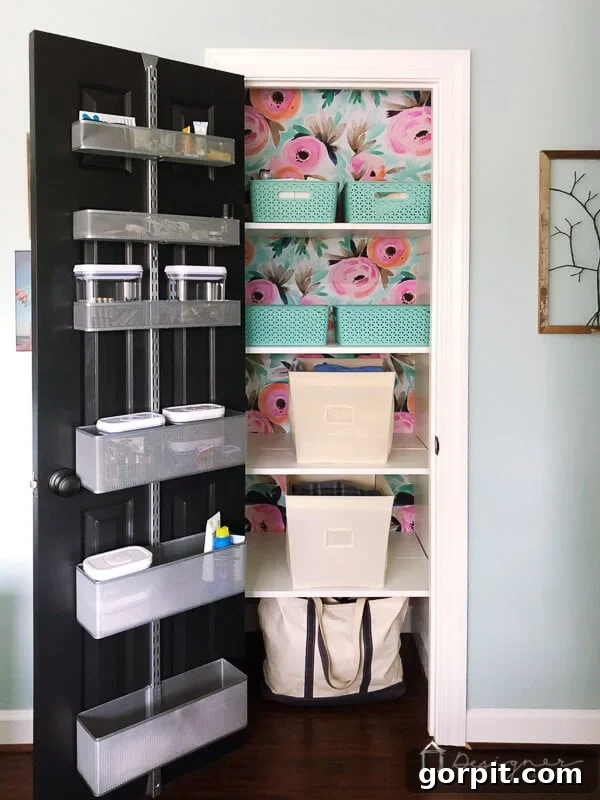 organized linen closet with floral wallpaper