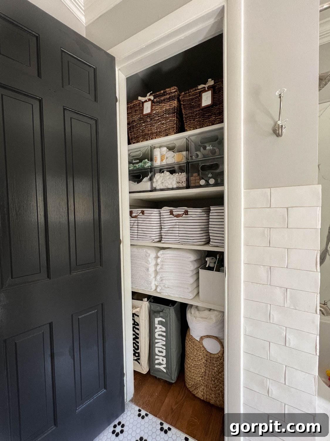 small bathroom linen closet that is neatly organized