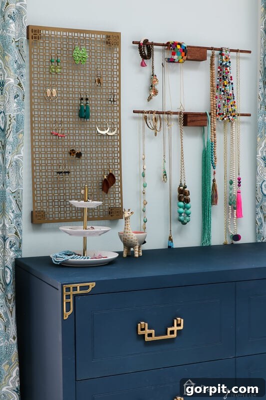 Tangle-Free Treasures: Easy DIY Jewelry Organization 13 Full view of the finished DIY hanging jewelry organizer on a wall, showcasing earrings, necklaces, and bracelets.