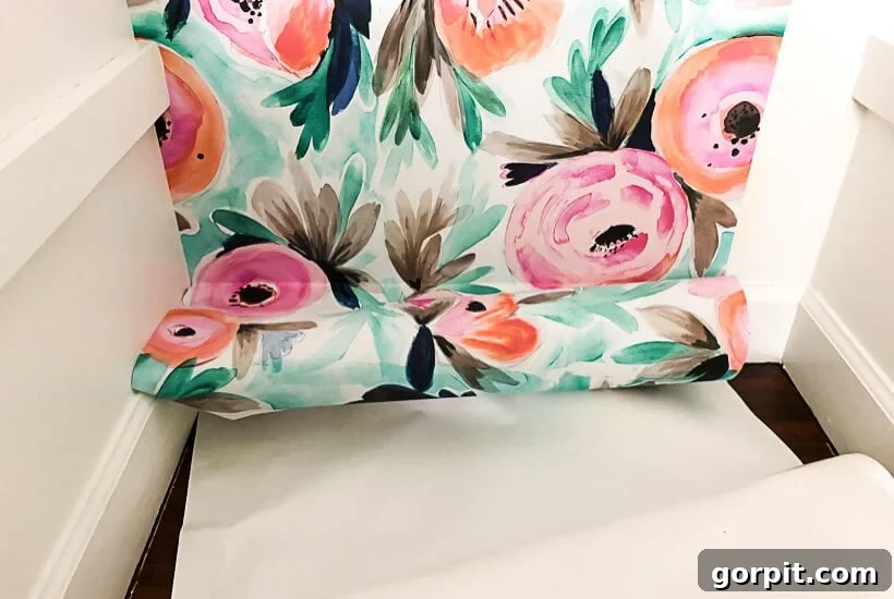 Vibrant floral removable wallpaper being installed in a closet, showing its ease of application for stunning home decor.