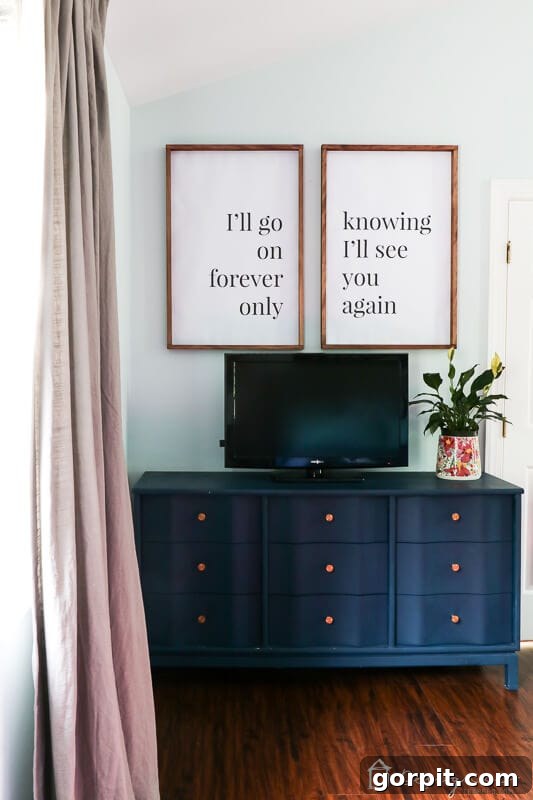 5 Habits That Keep Homes Beautiful 7 Curated decor above a TV in a bedroom, highlighting thoughtful placement of independent pieces in a cohesive design.