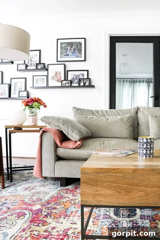Close-up of the West Elm Harmony sectional sofa, showcasing its soft cushions, deep seating, and distressed velvet fabric in a colorful family room setting.